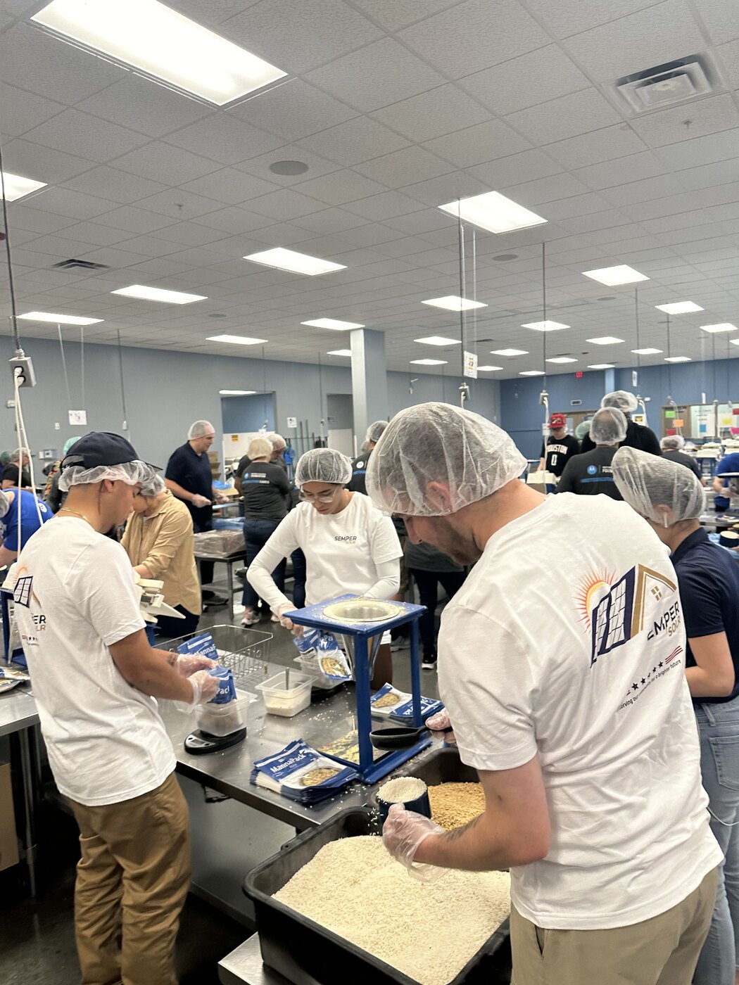 Semper SolR team volunteering at Feed My Starving Children